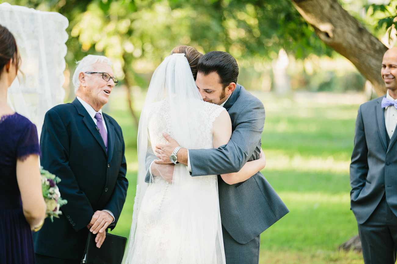 The bride and groom hugging. 