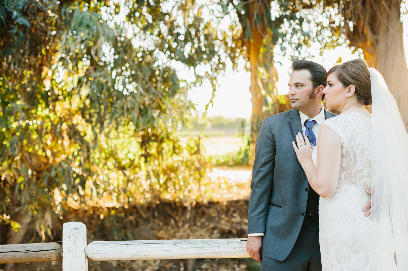 Whitney and JD leaning on a fence. 