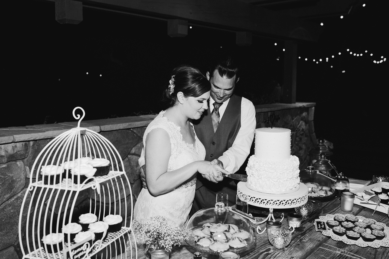 The bride and groom cutting the cake. 