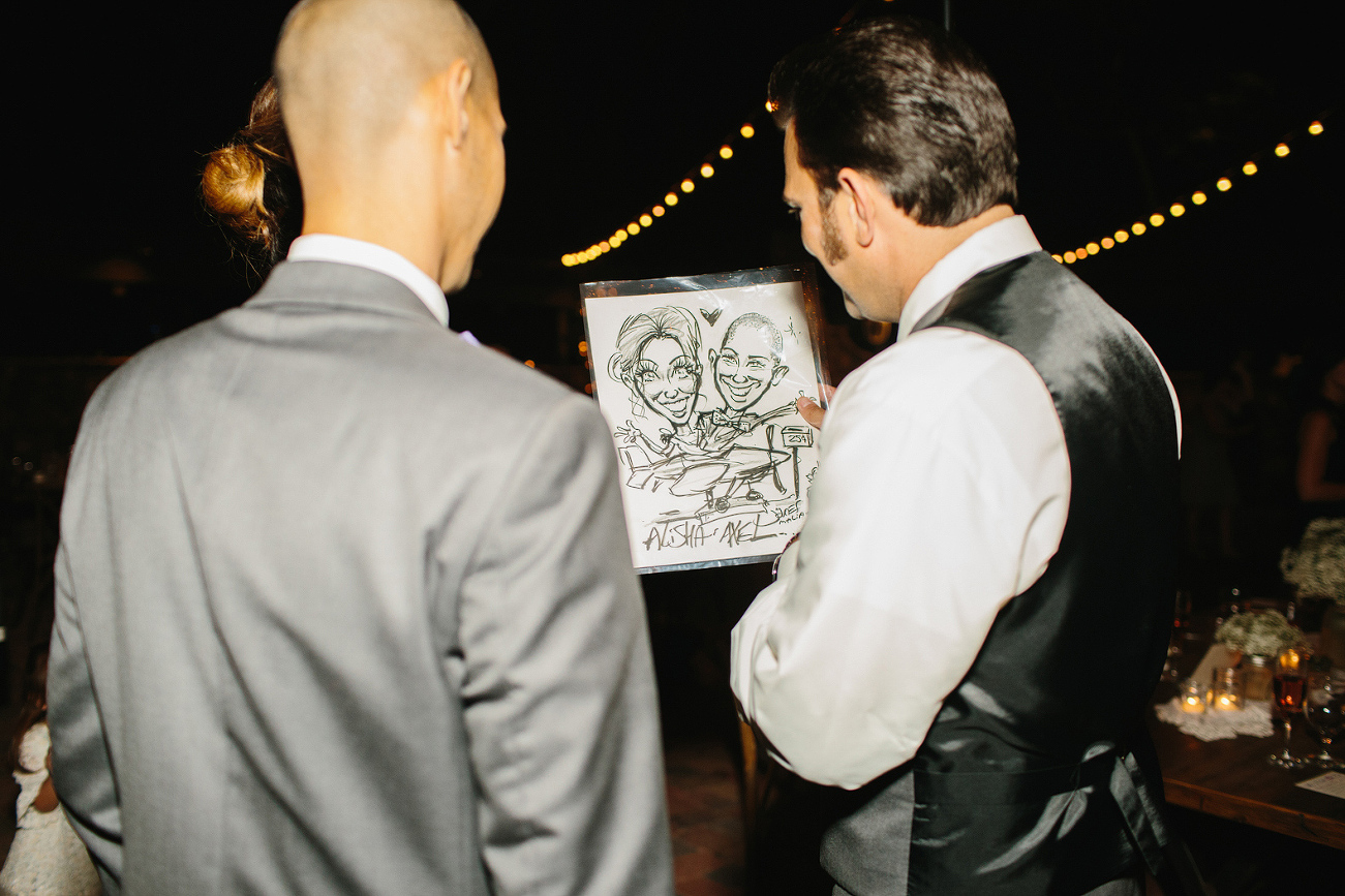 The groom looking at a drawing. 