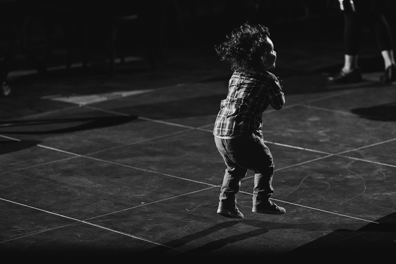 A kid dancing during the reception. 