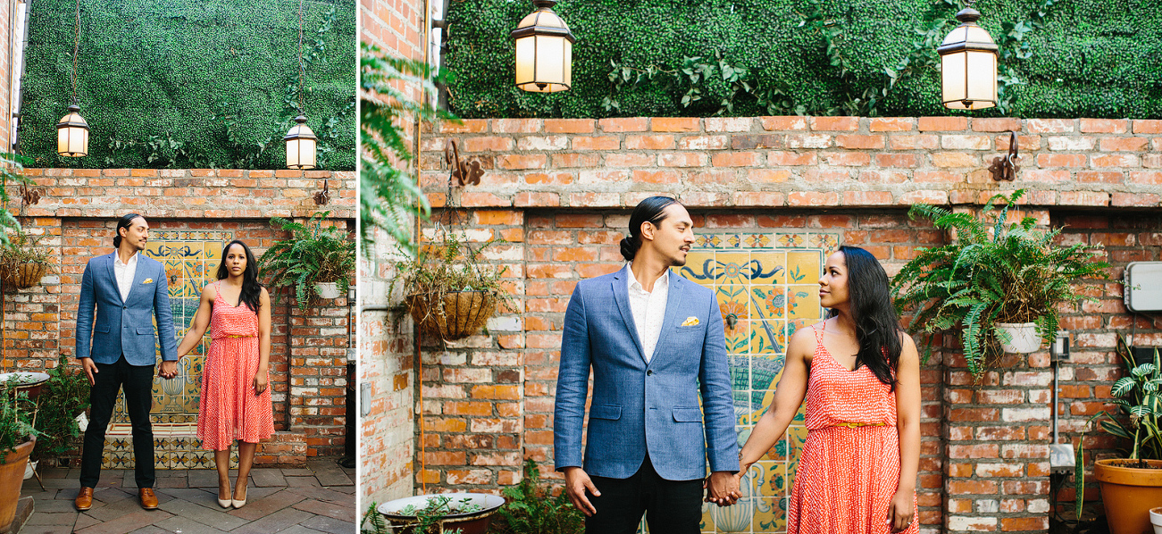 Alanna and David in front of a brick and tile wall. 