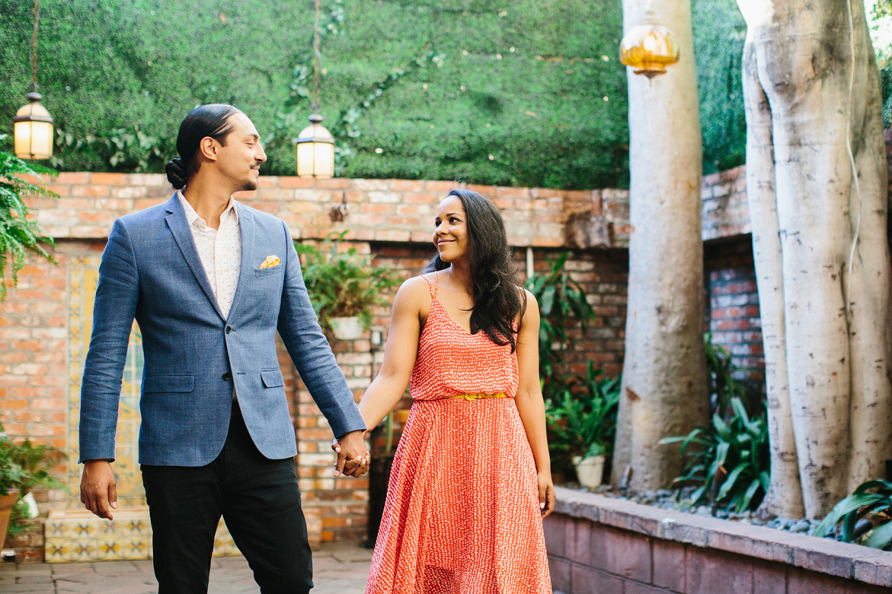 The engaged couple walking together. 