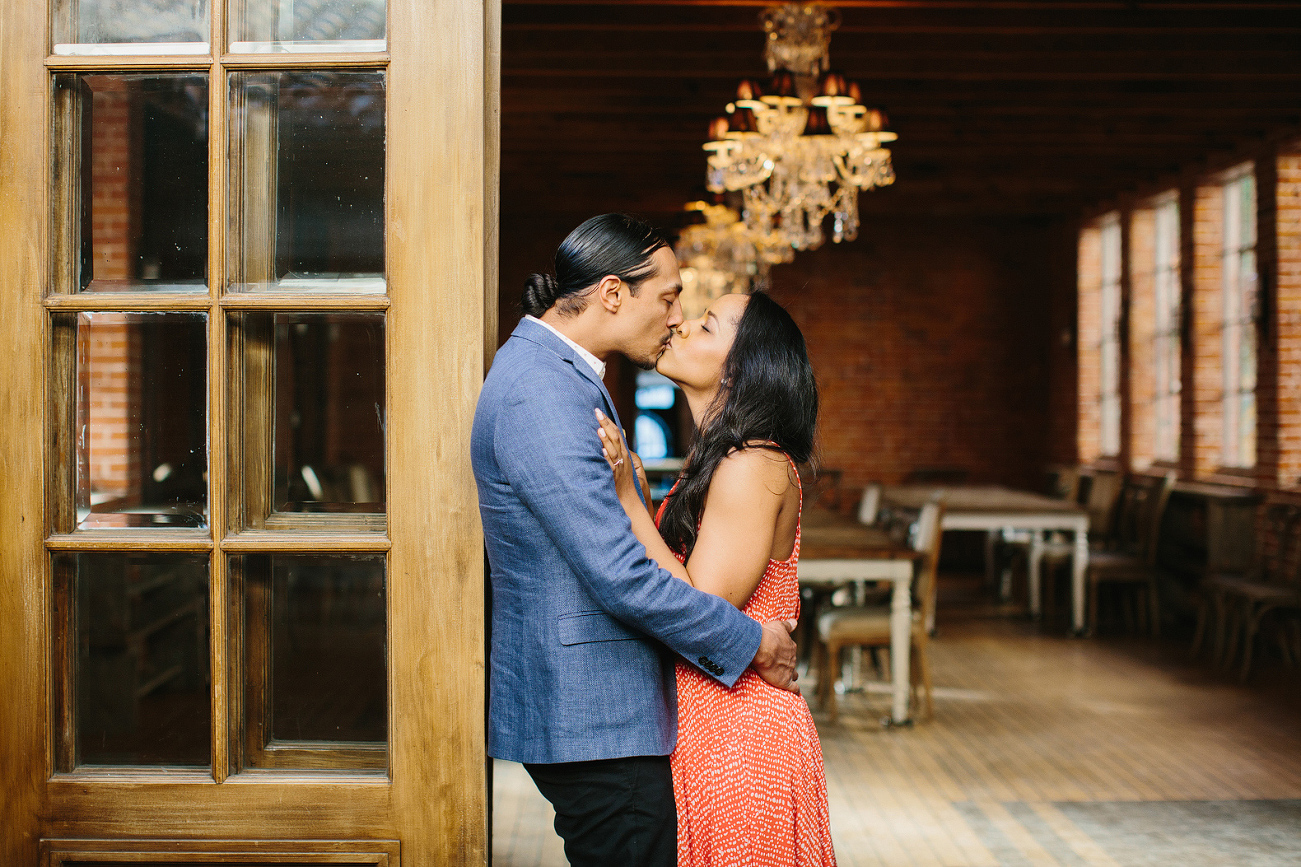 The couple leaning on a door. 