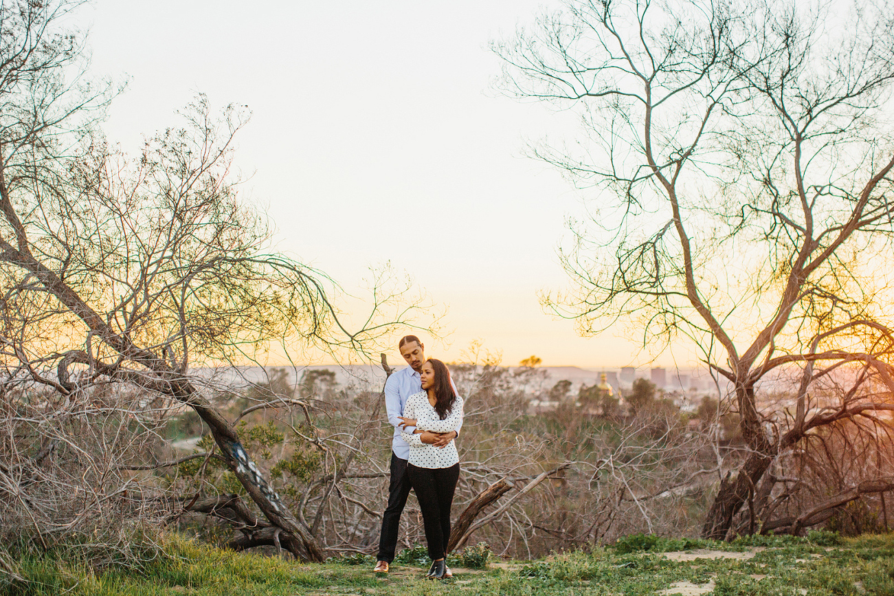 The couple in a park at sunset. 