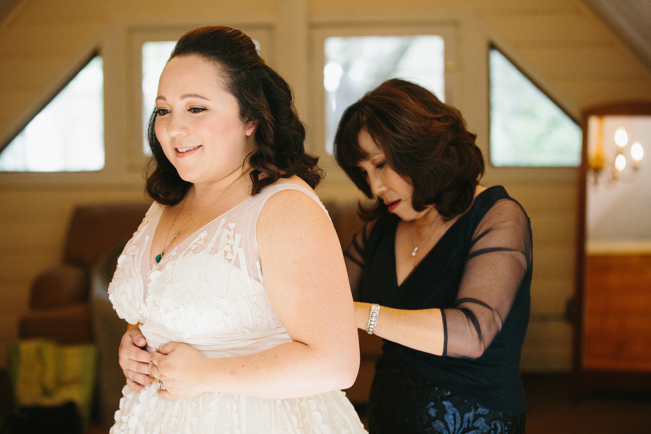 The bride getting in her wedding dress. 