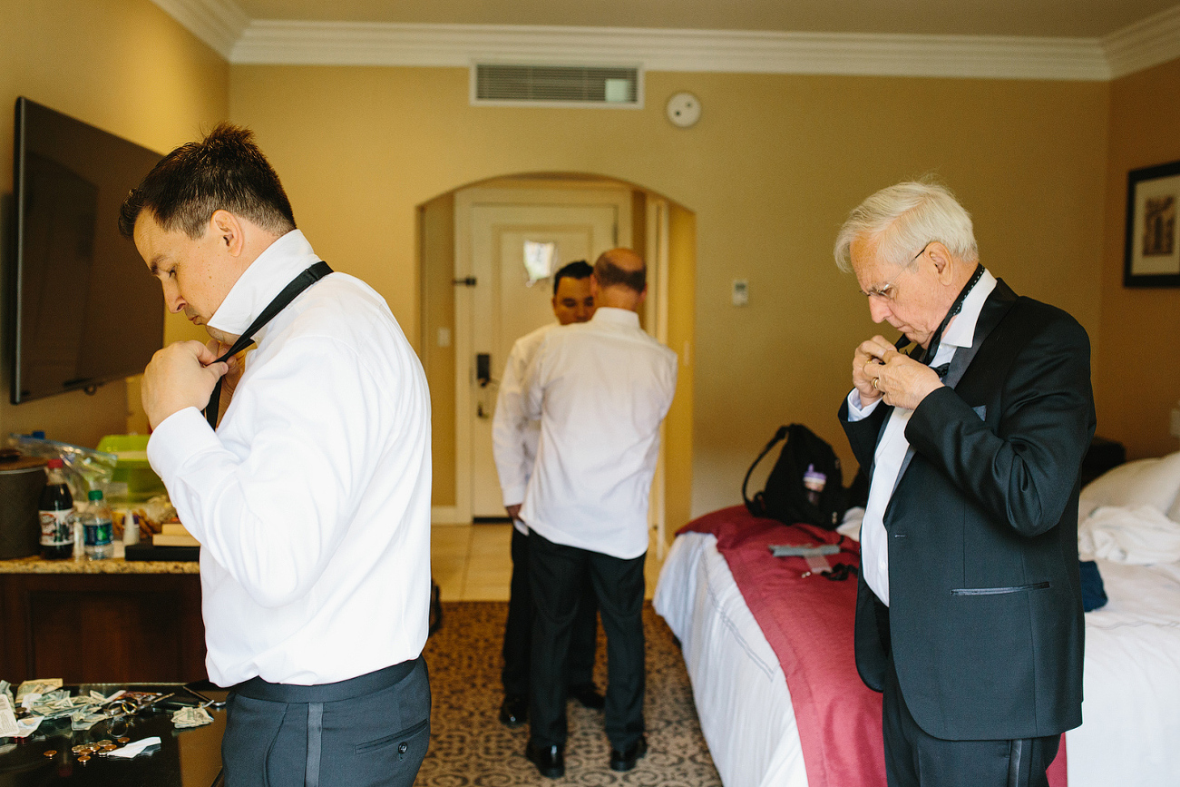 The groom and his dad tying their bowties. 