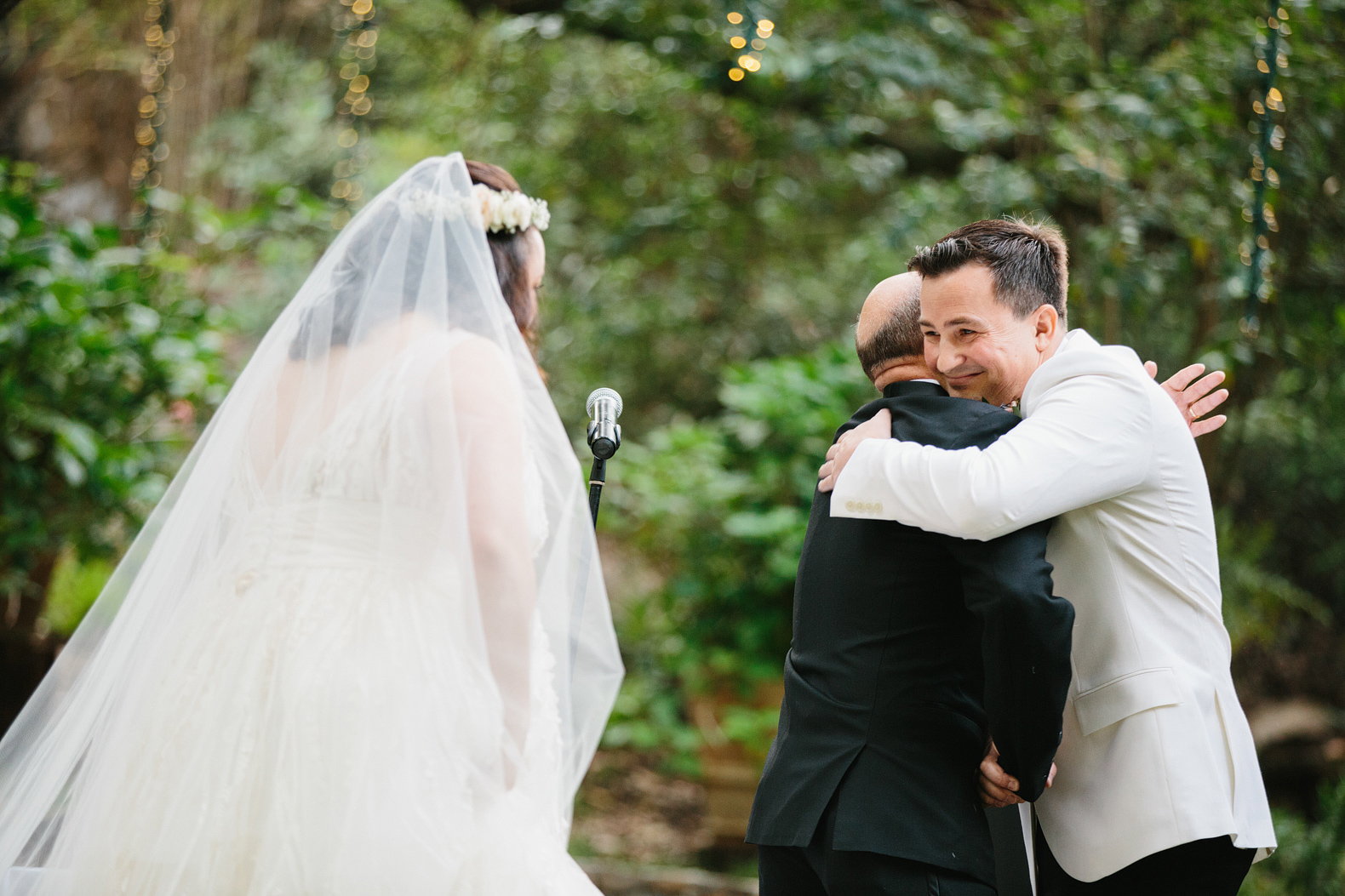The groom hugging the bride's father. 