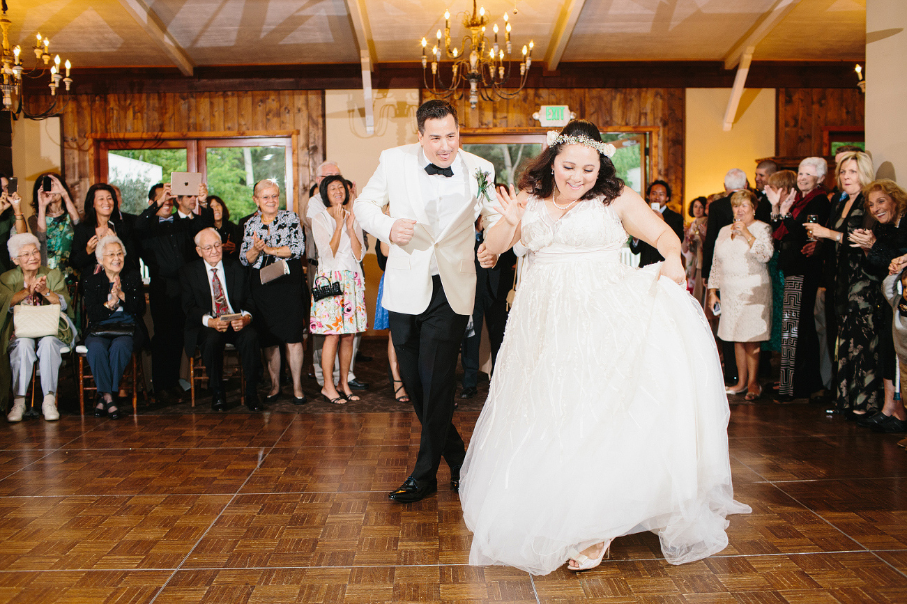 The couple dancing as they enter the reception. 