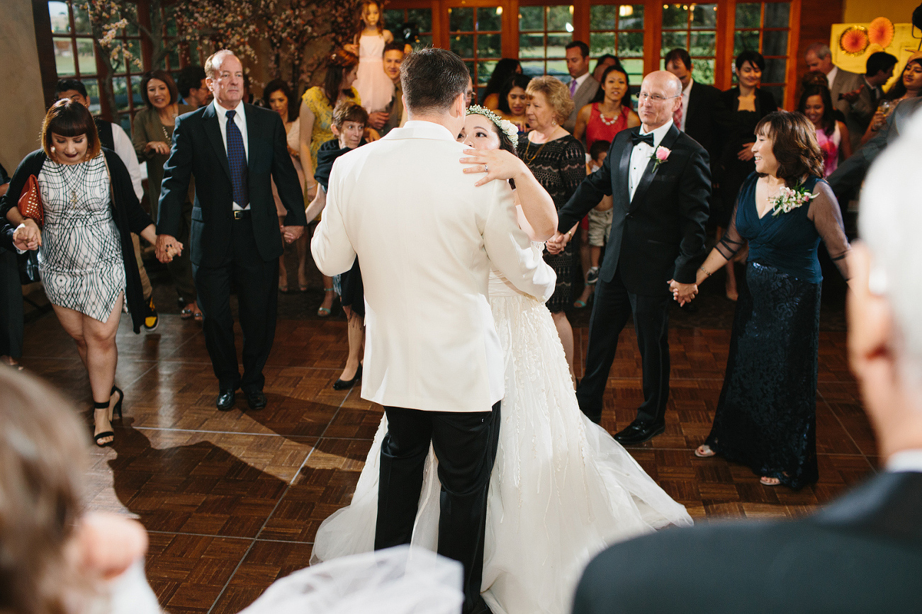 The bride and groom surrounded by their guests. 