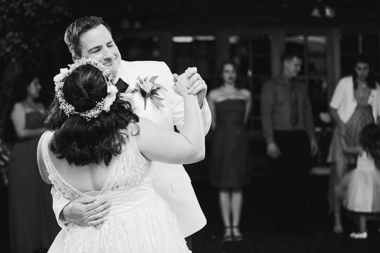 The bride and groom dancing together. 