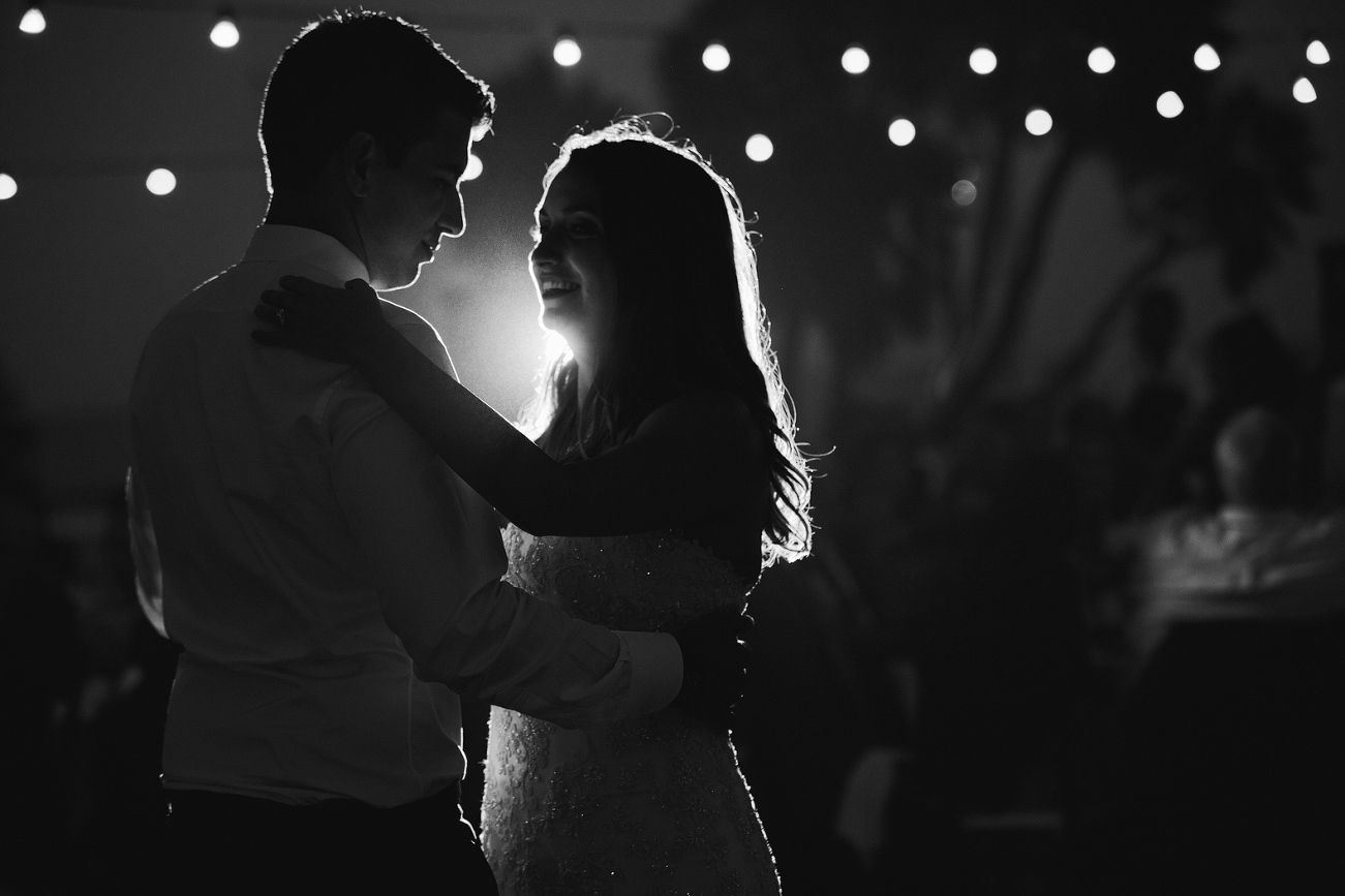 A beautiful black and white portrait of the couple dancing. 