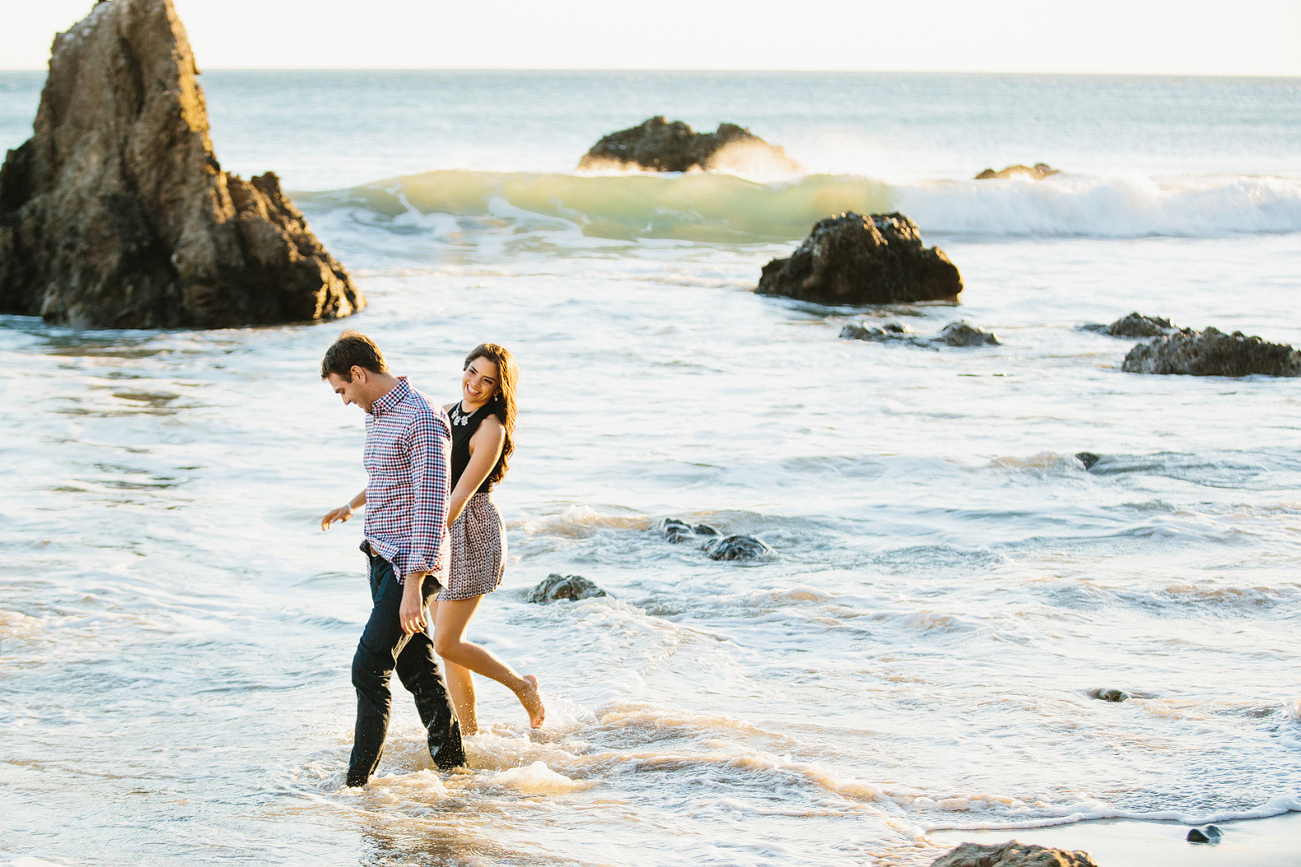 Miren and Peter walking in the water. 