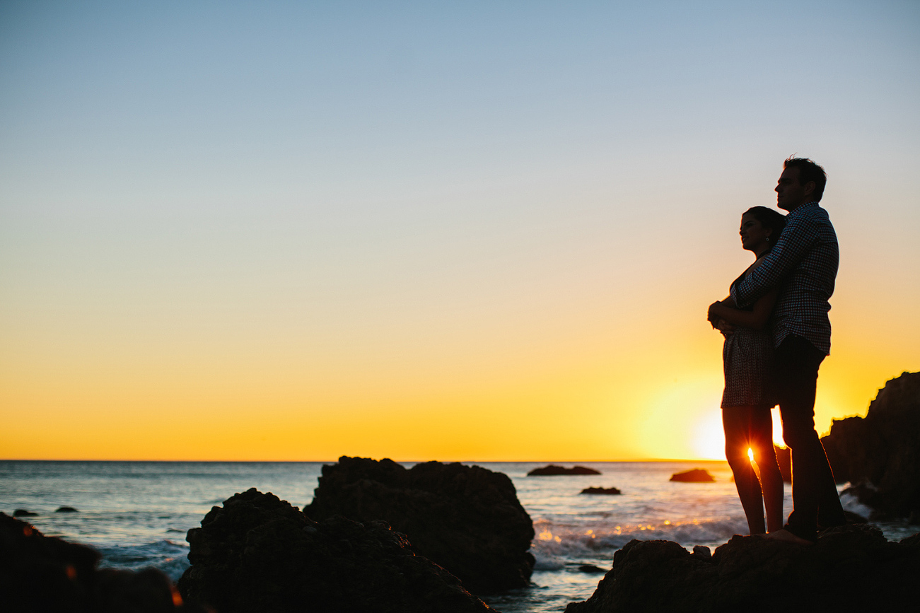 Miren and Peter on a rock at sunset. 