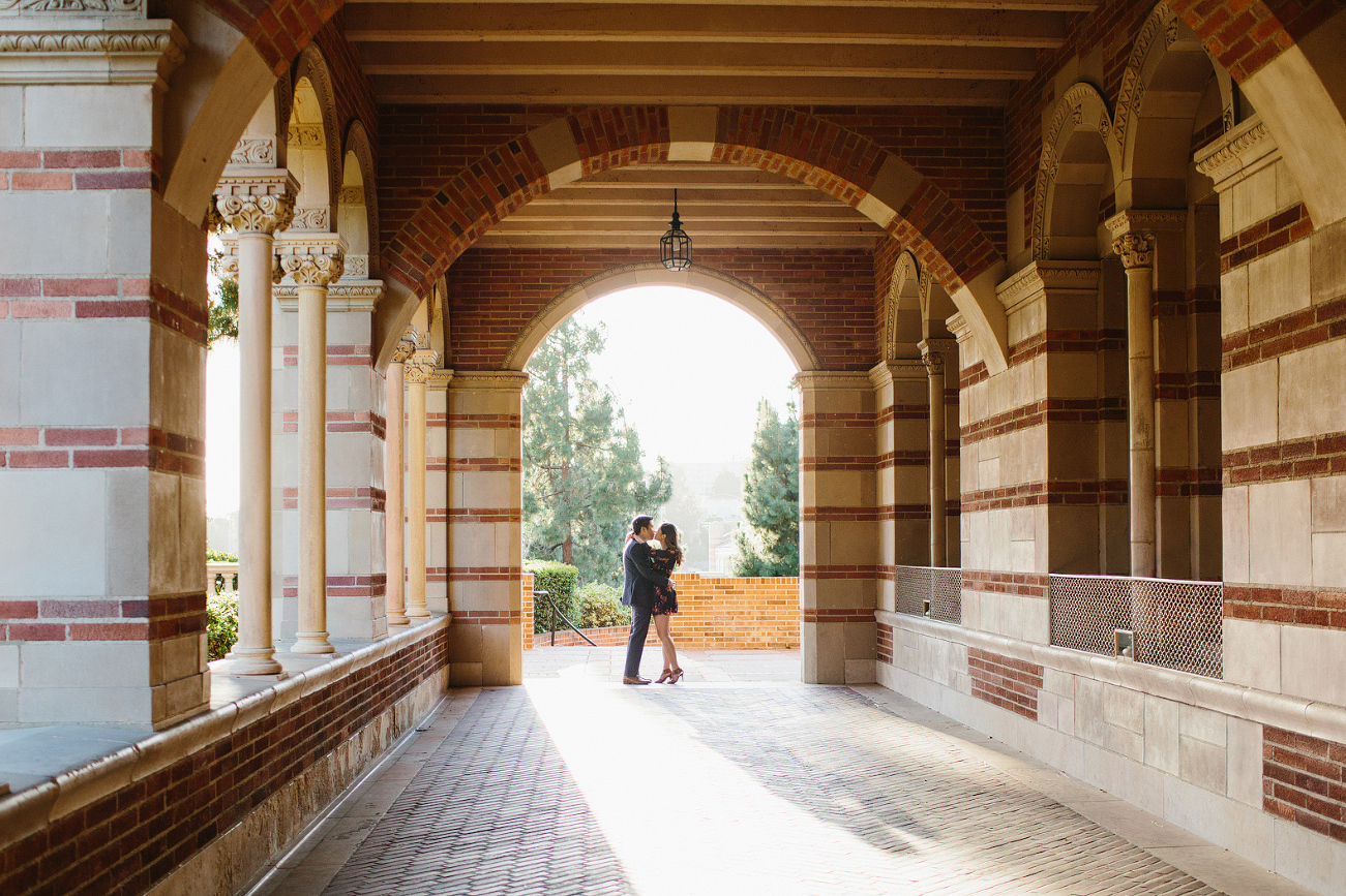 Nikki and Chad standing in a brick hallway. 