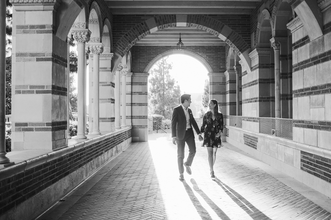 A black and white photo of the couple walking. 