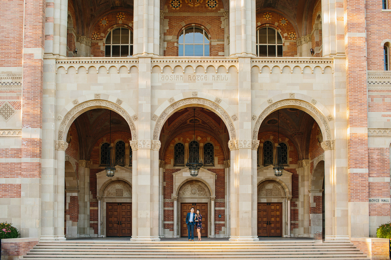 The couple in front of a building. 