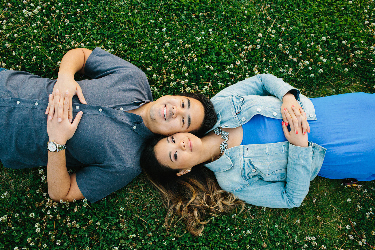 Nikki and Chad laying on the grass. 