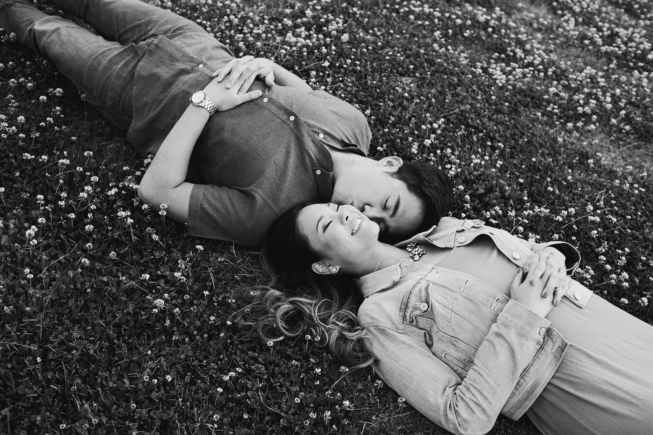 A black and white photo of the couple on the grass. 