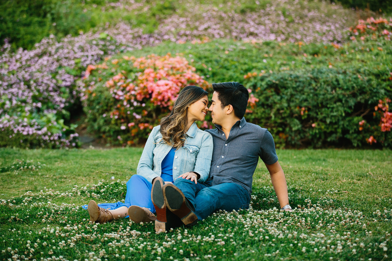 The couple by bright flowers. 