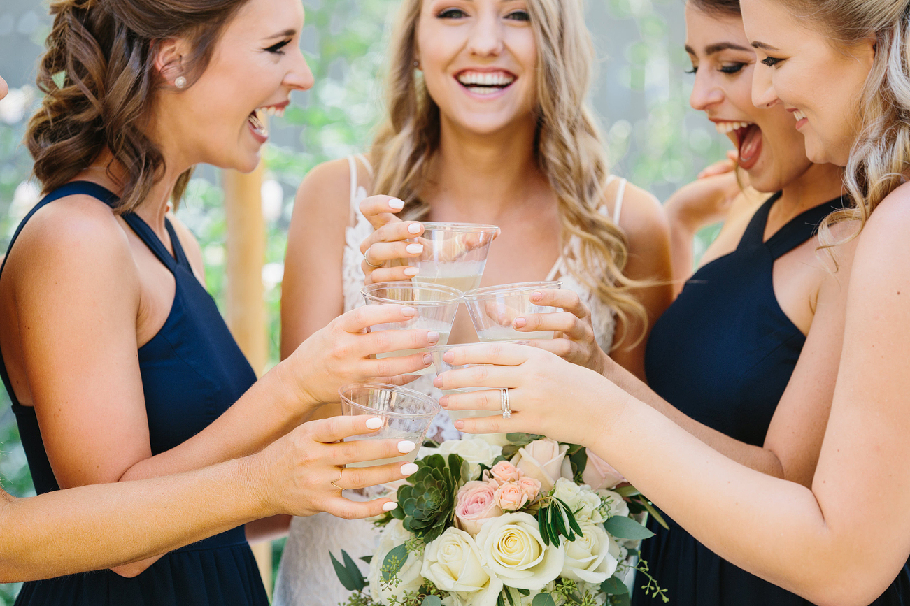 Bride toasting with bridesmaids on wedding day