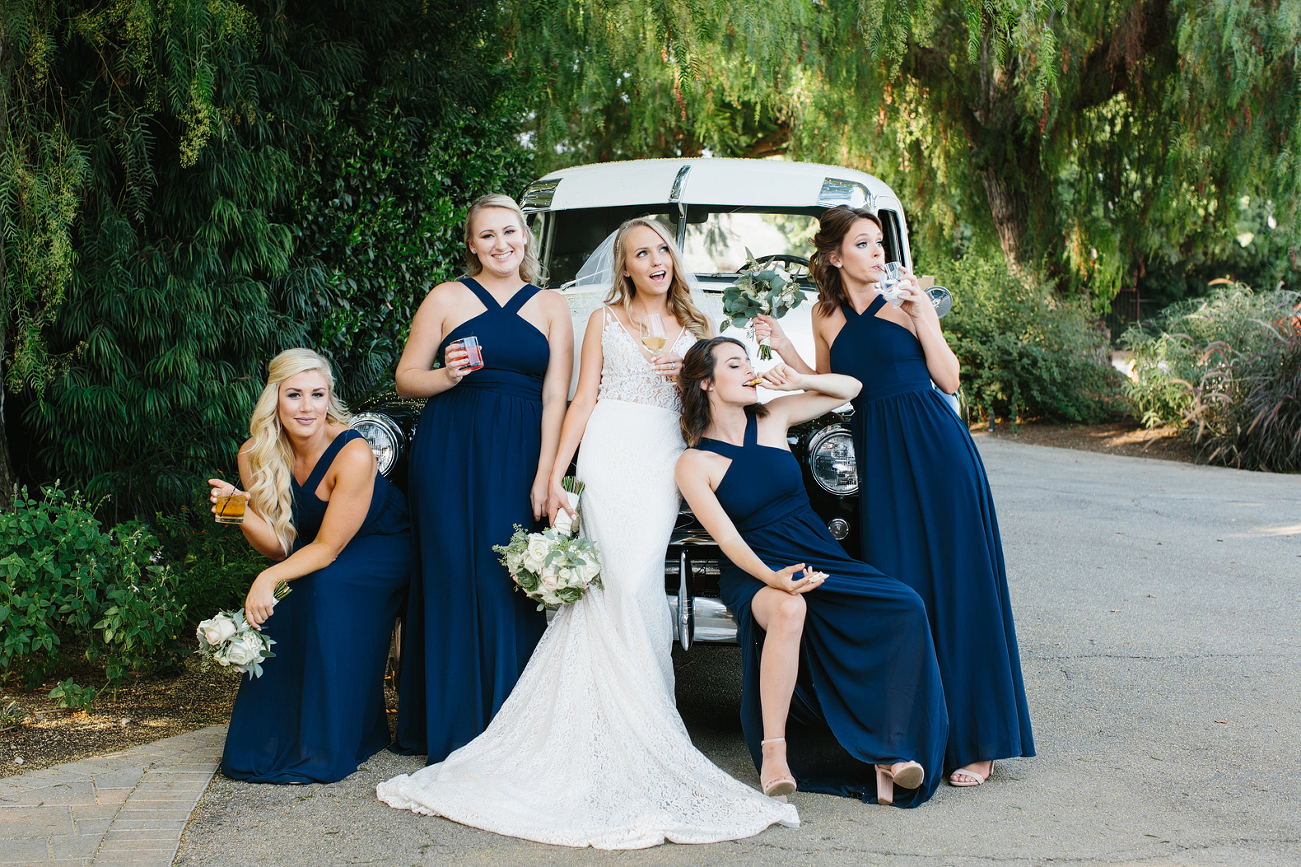 Sassy bridesmaids posing on truck