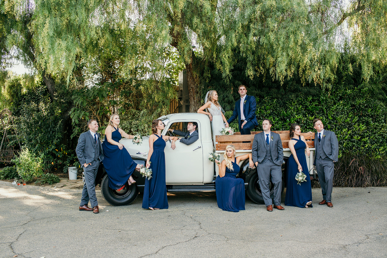 Wedding party on a vintage truck at garden wedding