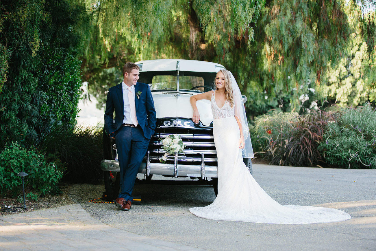 Bride and Groom at garden wedding with vintage truck