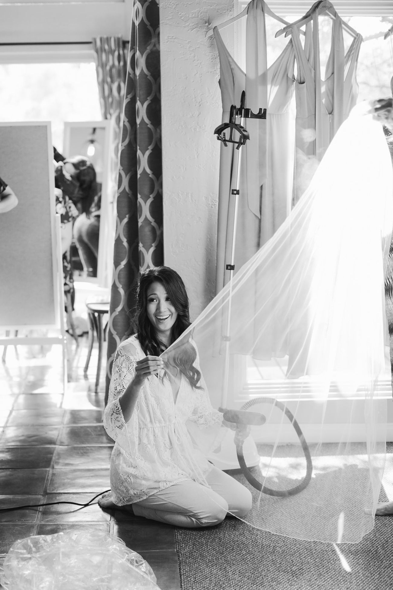 bride steaming her veil on her wedding day