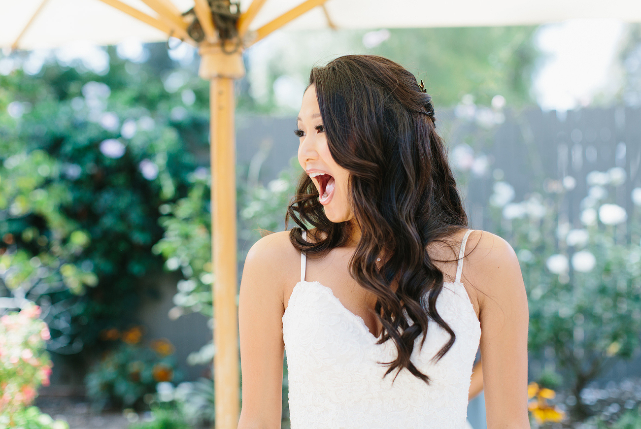 happy bride when she sees her flowers and her friends