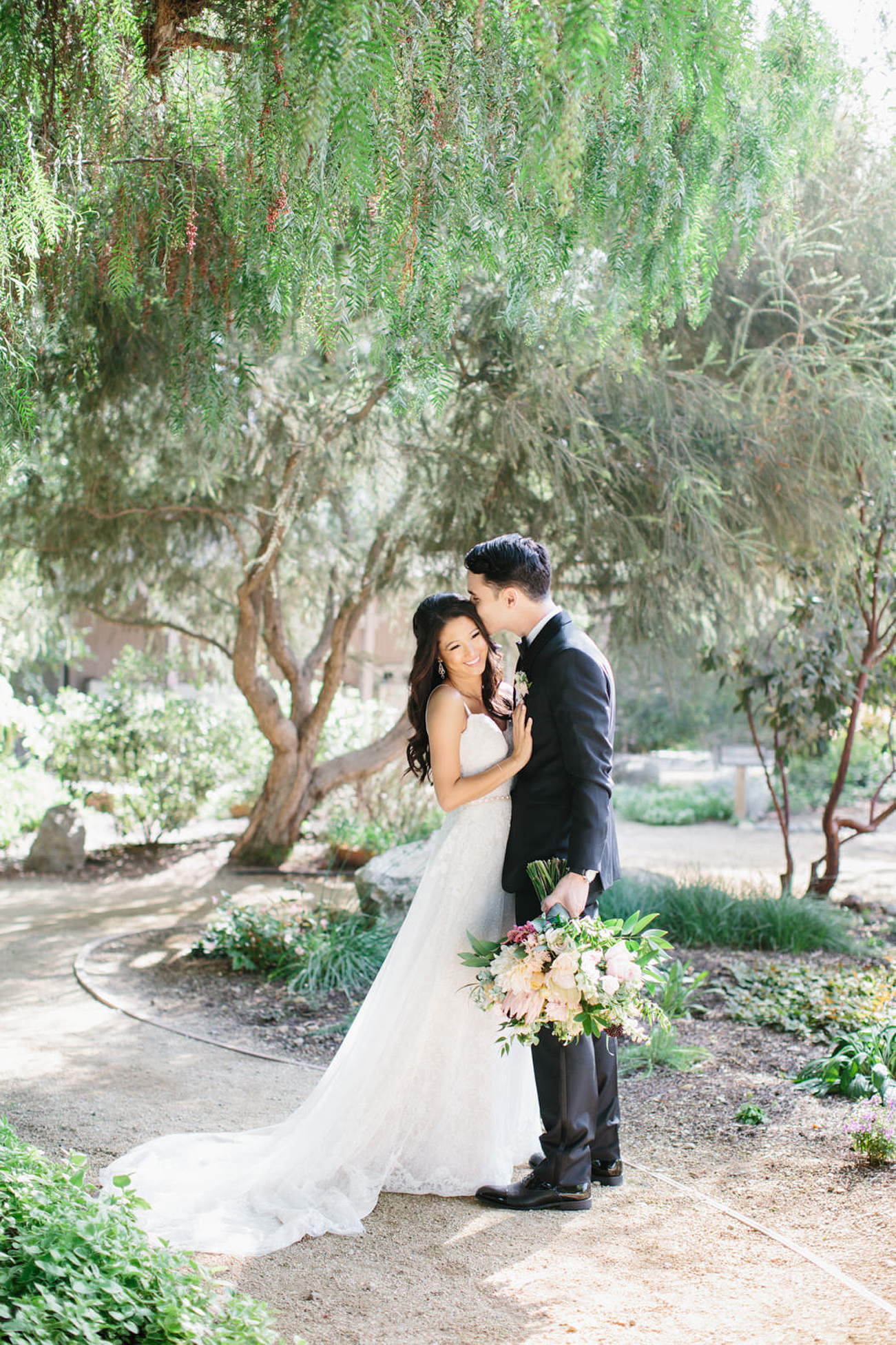 Groom kissing his beautiful bride on their big day