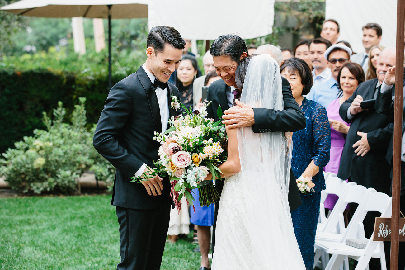 father of bride giving her away at ceremony