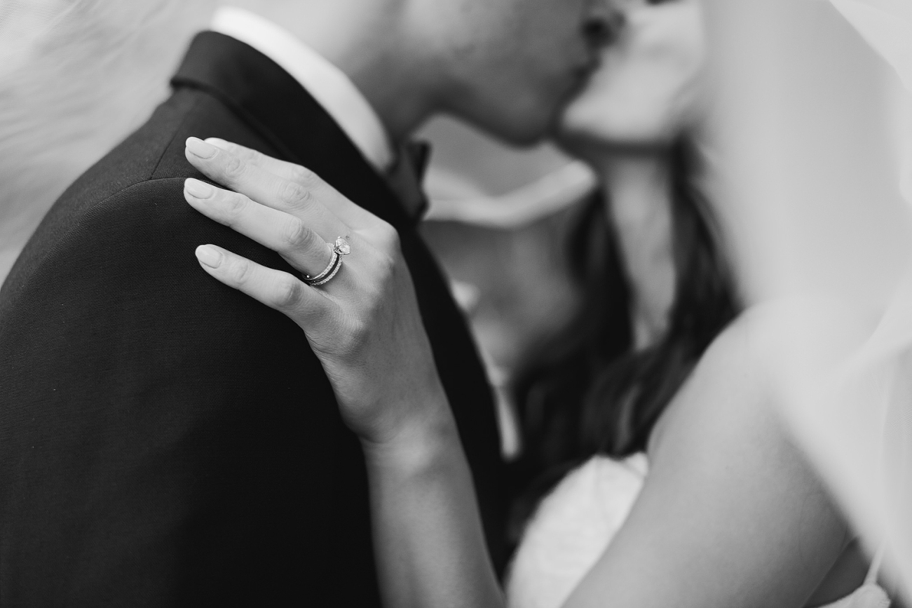 close up of wedding rings and hands