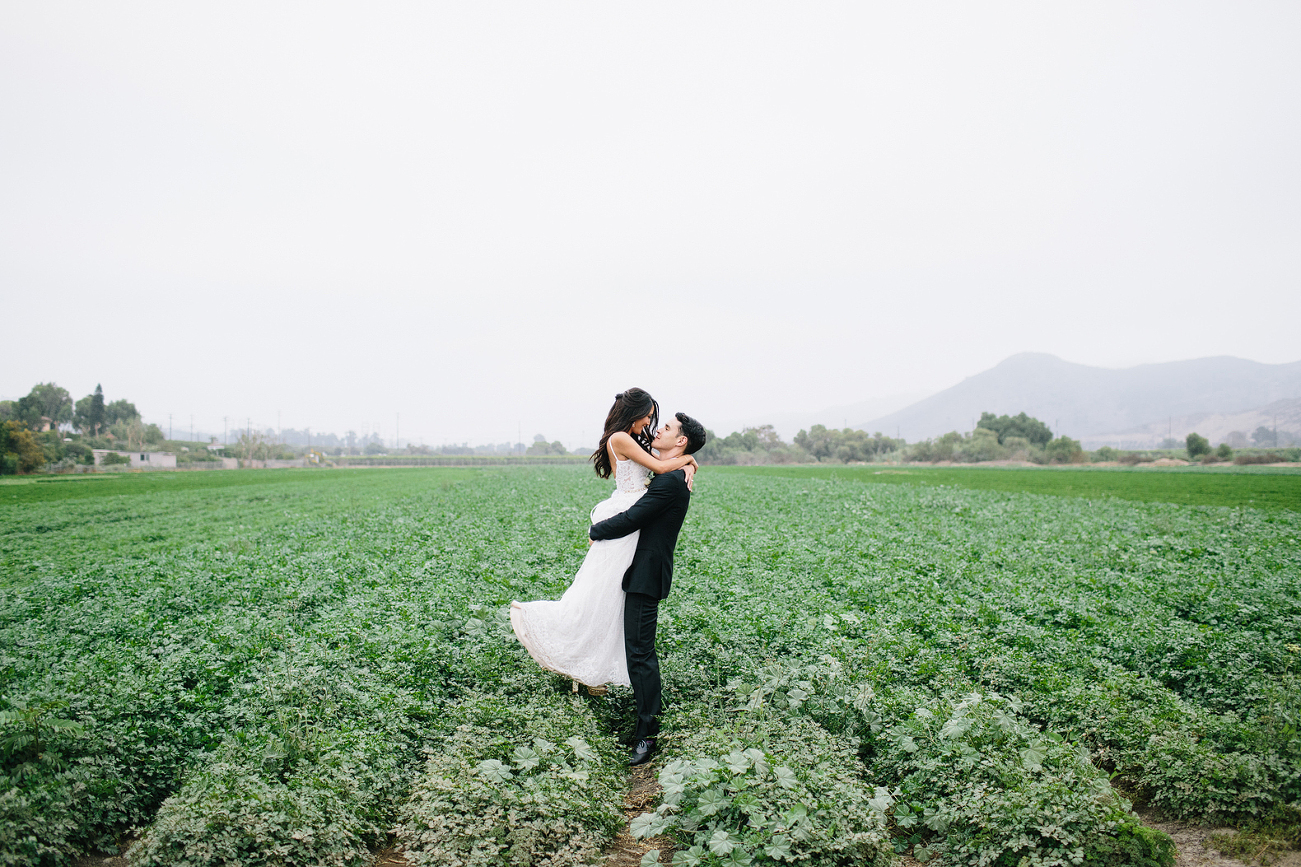 husband and wife in a green field