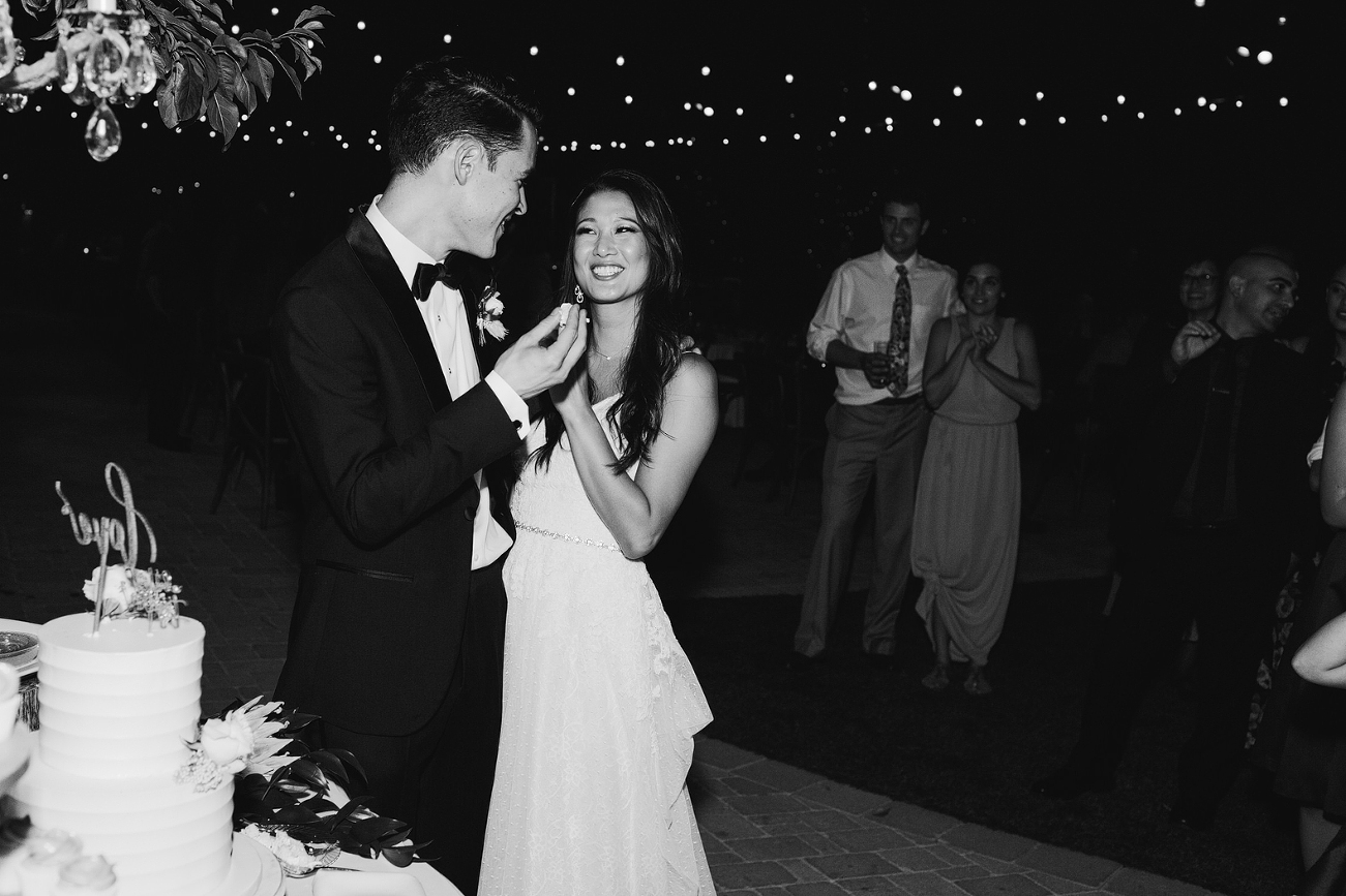 bride and groom feeding eachother cake