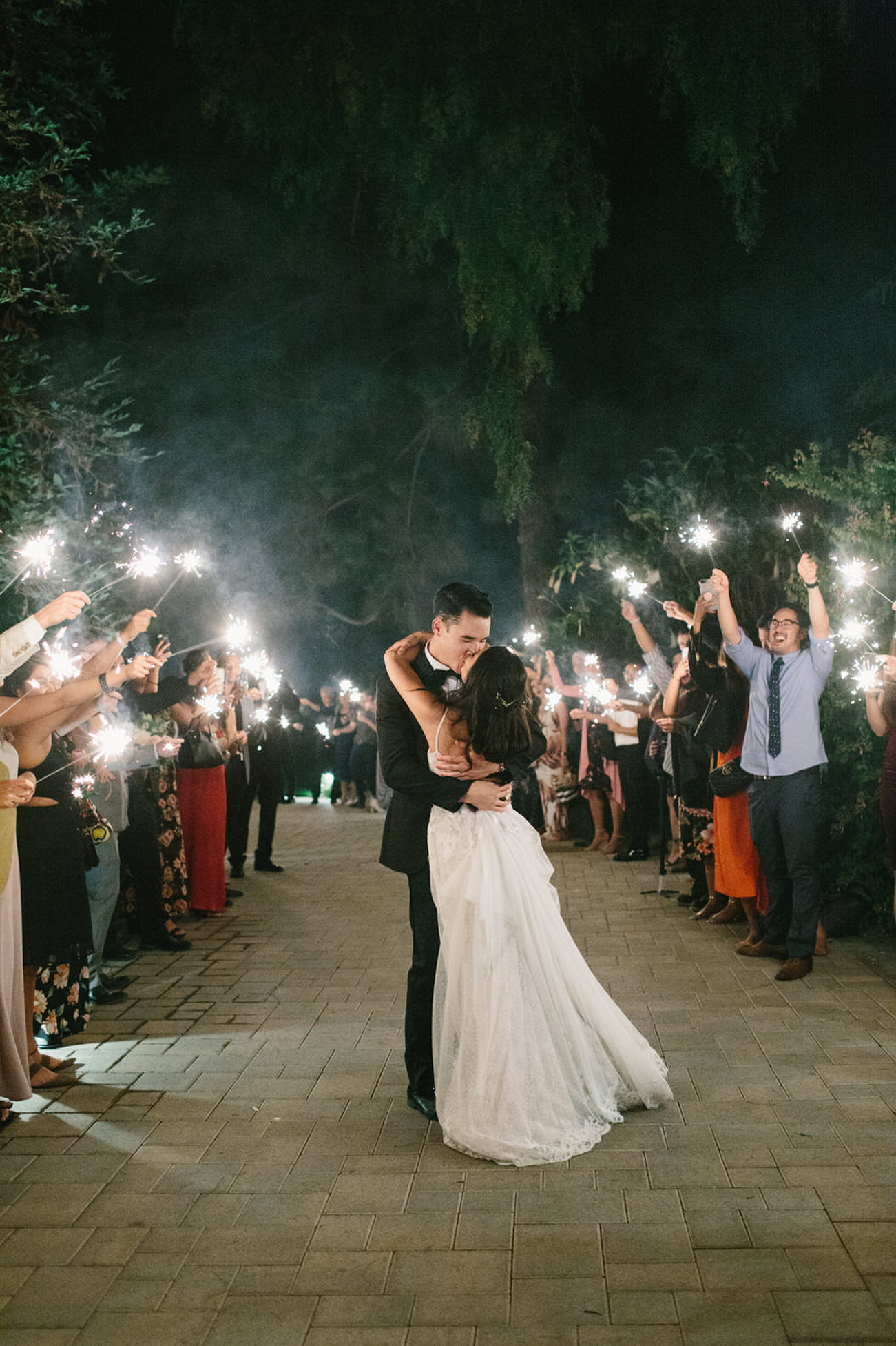 kiss at the sparkler firework exit on wedding day