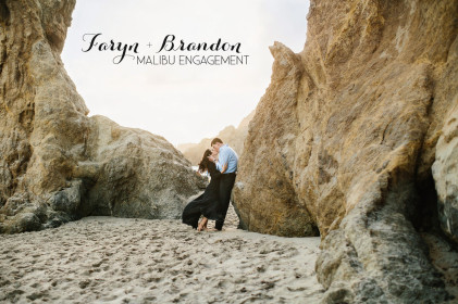 Title image of engaged couple kissing with the wind blowing in her dress