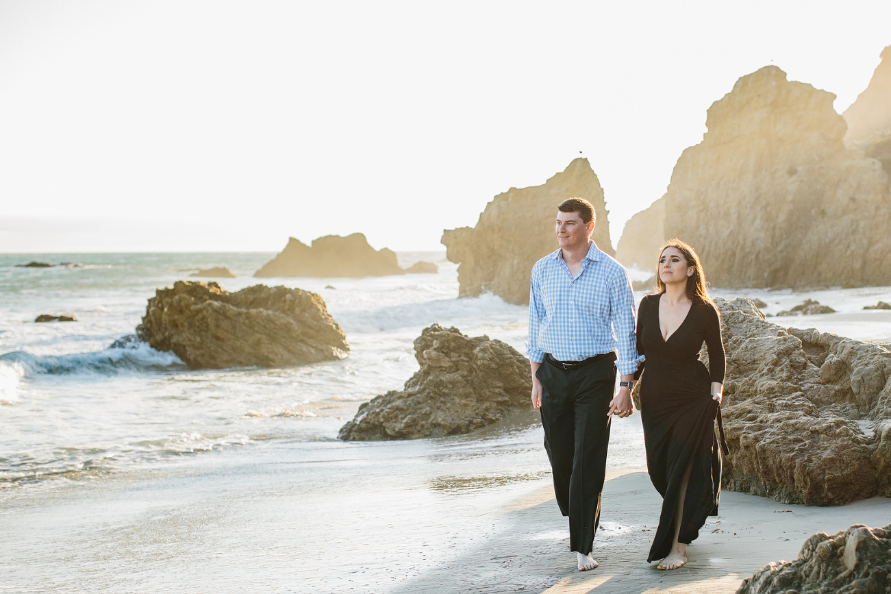 engagement photo with warm glow of sun on the beach